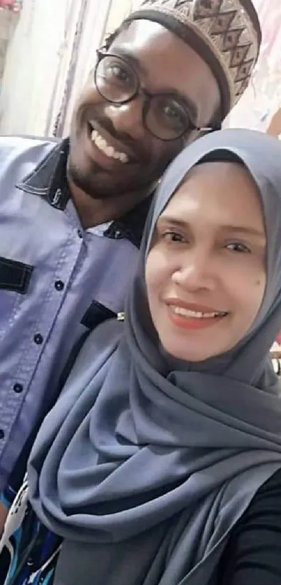 Smiling couple in traditional attire with festive decorations.