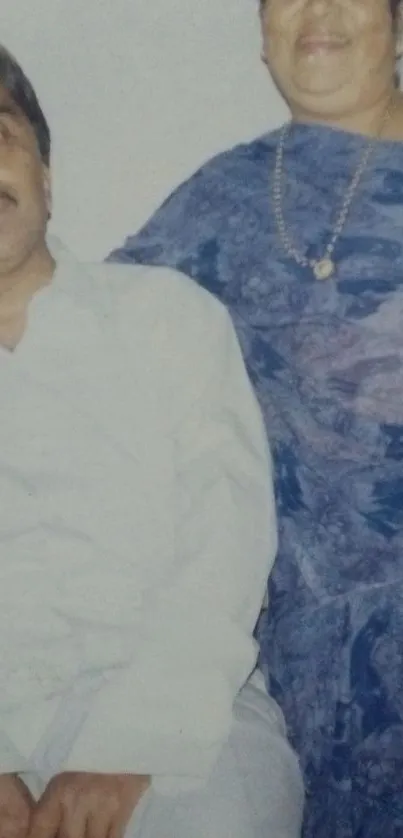 Smiling couple wearing traditional attire captured in a portrait.