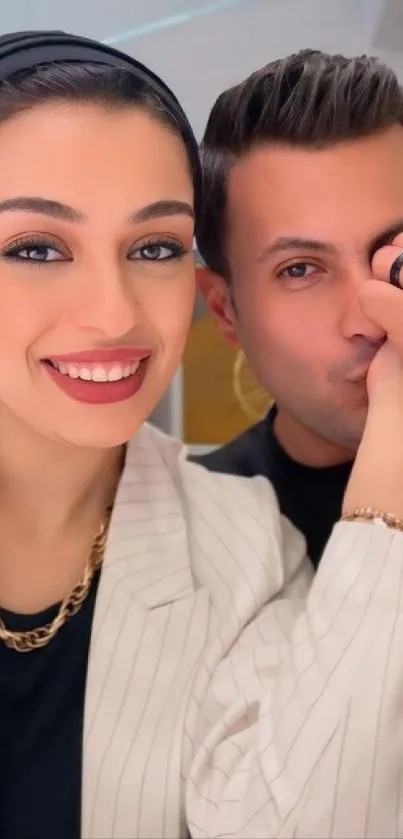 Smiling couple in elegant attire, close-up.