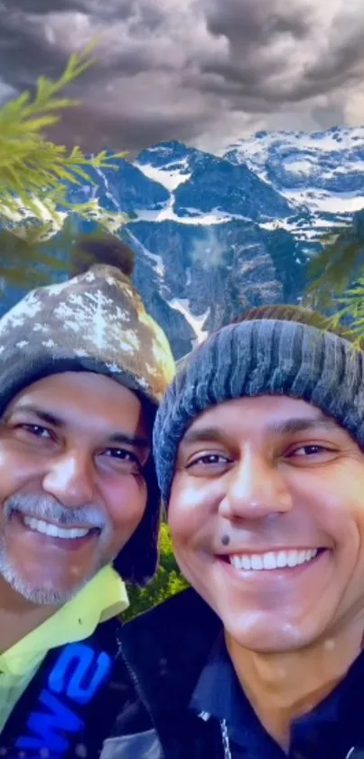 Two men smiling in front of snowy mountains under a cloudy sky.