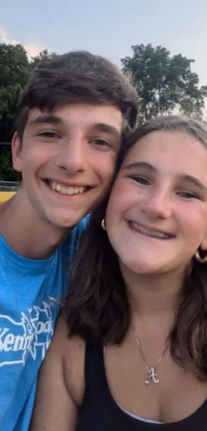 Teenagers smiling outdoors on a sunny day