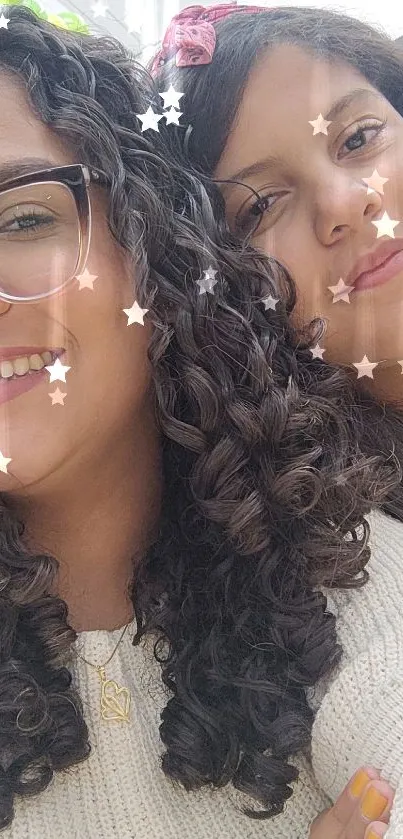 Two friends with curly hair smiling brightly, colorful background.