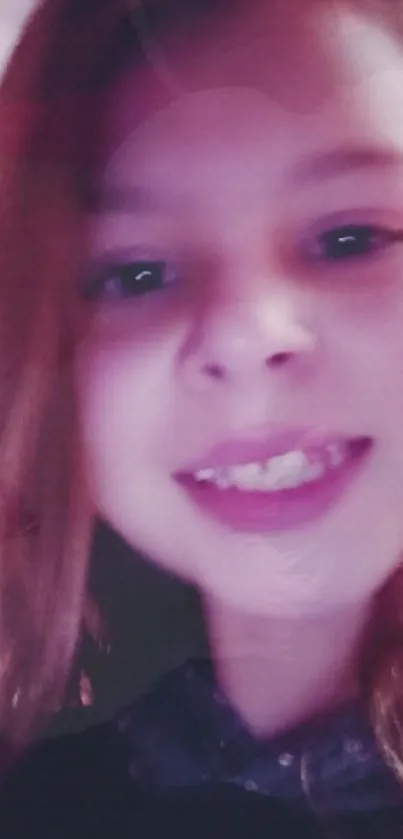 Smiling young girl in soft pink light.