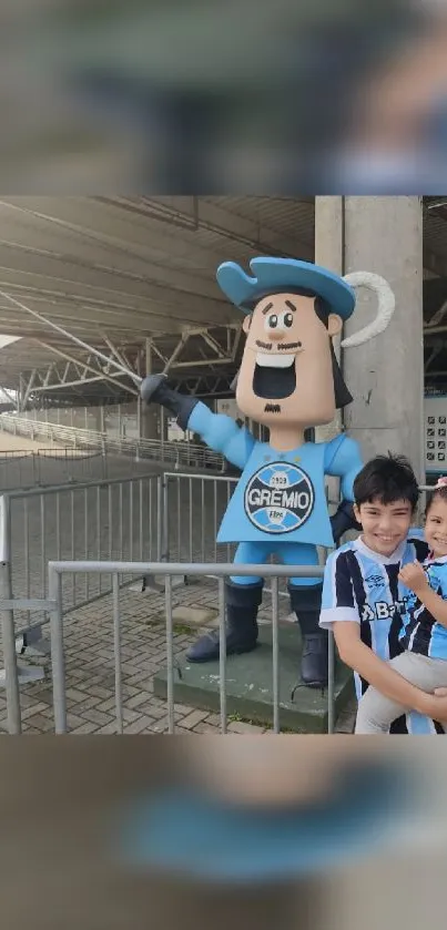 Children smiling with Grêmio mascot at stadium.