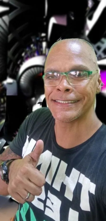 Smiling man in glasses with abstract black background.