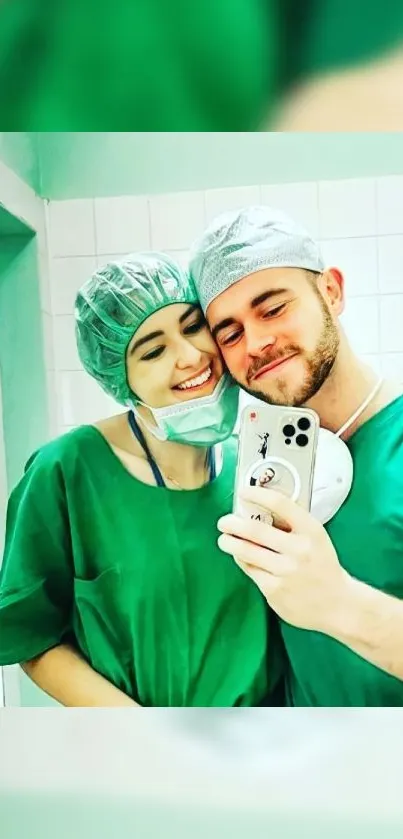 Smiling medical professionals in green scrubs taking a selfie.