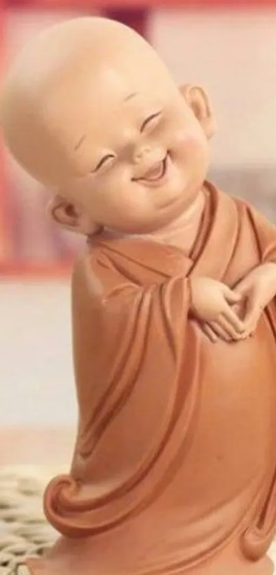 Smiling Buddhist monk figurine in light brown robe.