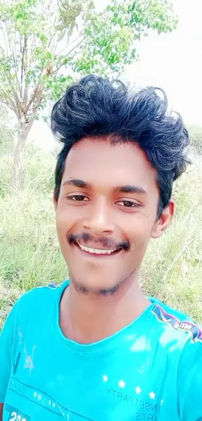 Smiling person outdoors with blue sky.