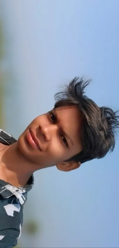 Portrait of a smiling teen with a blue sky background.