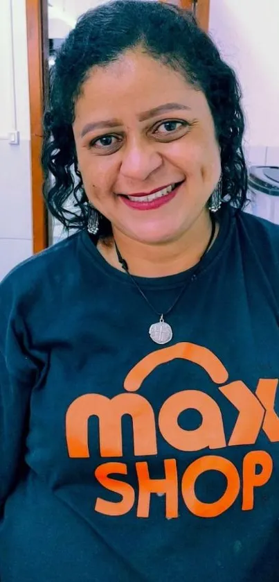 Cheerful woman wearing Max Shop T-shirt smiling.