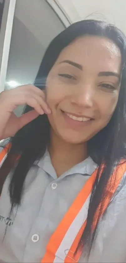 Smiling woman in safety vest at office.