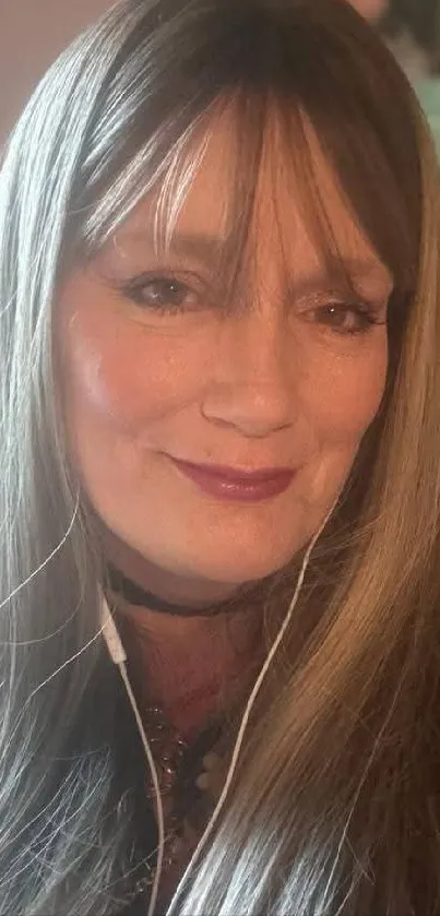 Portrait of a smiling woman wearing headphones.