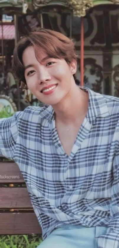 Cheerful young man sitting on a park bench with a smile.