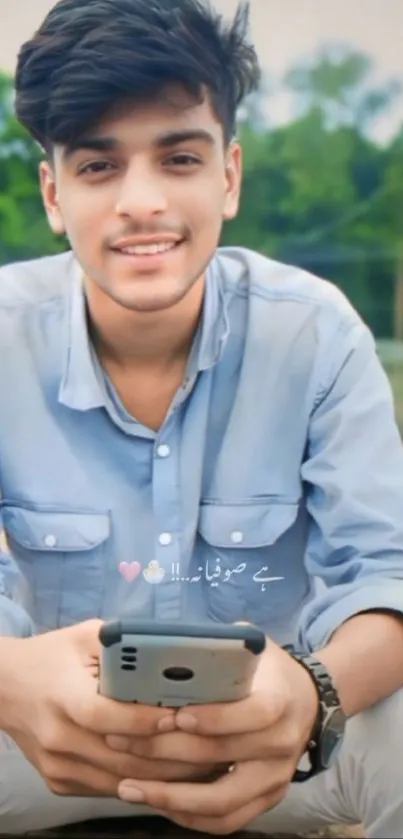 Smiling young man holding a smartphone outdoors.