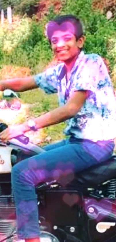 Boy joyfully riding a motorcycle in green setting.