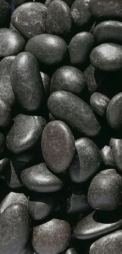 Smooth black stones mobile phone wallpaper, offering a calming and natural look.