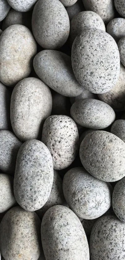 Arrangement of smooth gray stones for mobile wallpaper.