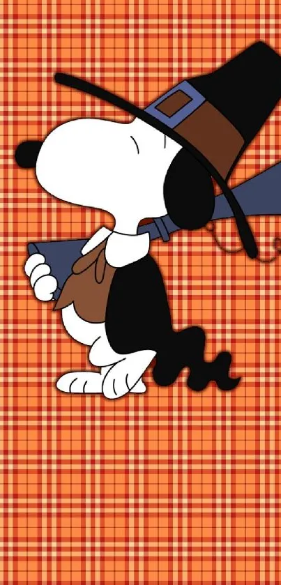 Snoopy dressed as a pilgrim on orange plaid wallpaper.