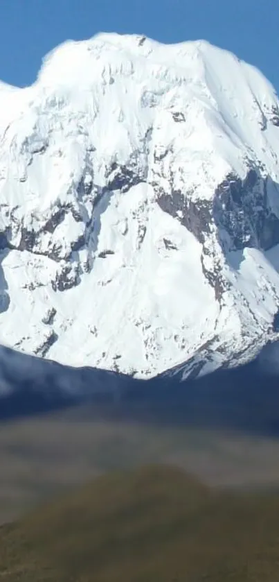 Snow-capped mountain peak under a blue sky, perfect for nature lovers.