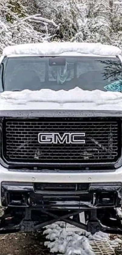 Snow-covered GMC truck in winter scene, mobile wallpaper.