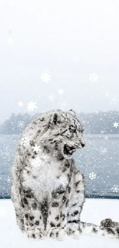 A snow leopard sitting by a frozen lake in a scenic winter setting.