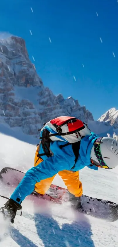 Vibrant snowboarder on snowy mountain under clear blue sky.