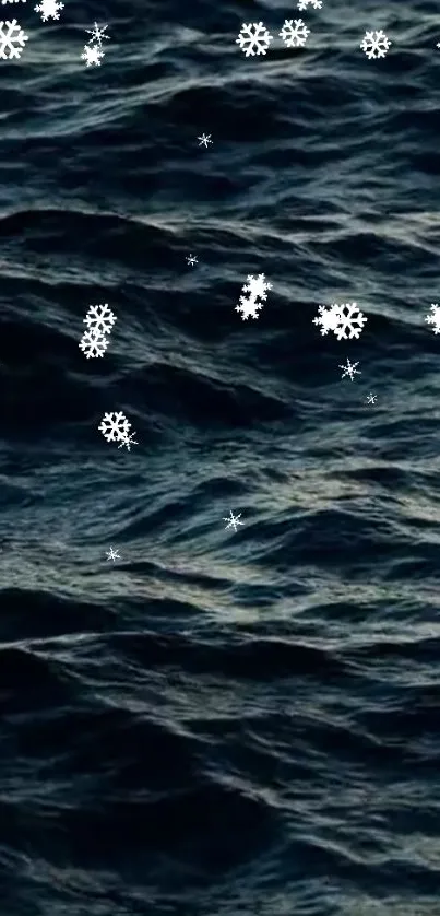 Dark ocean waves with drifting snowflakes, creating a peaceful winter scene.