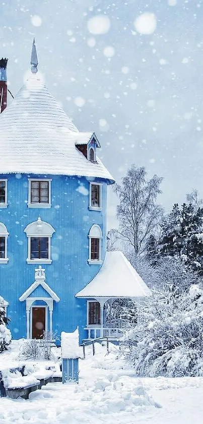 Blue house in snowy winter landscape with trees.