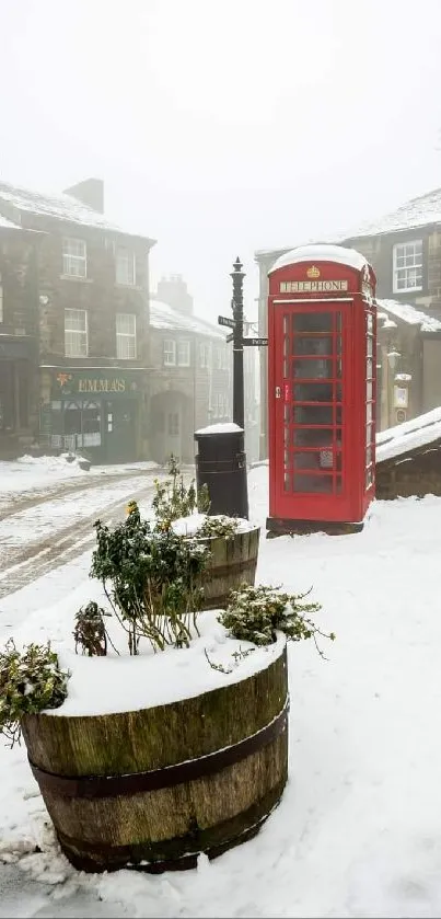 A red phone booth on a snowy British street.