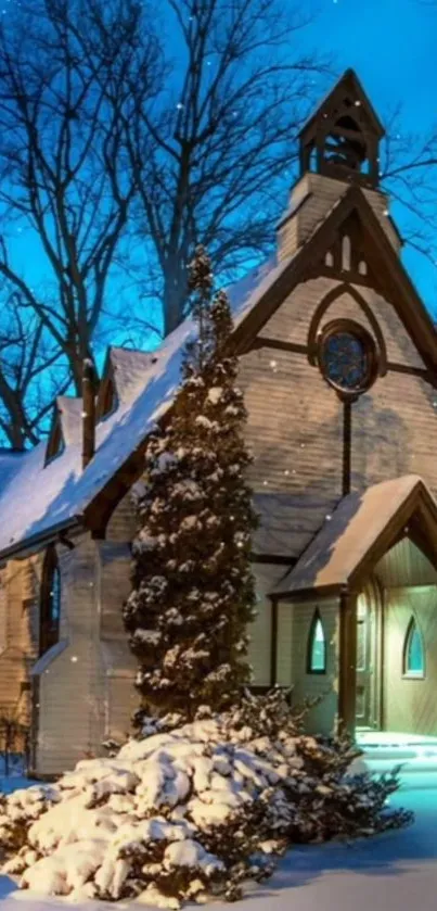 Snow-covered church at dusk with blue sky and twinkling lights.