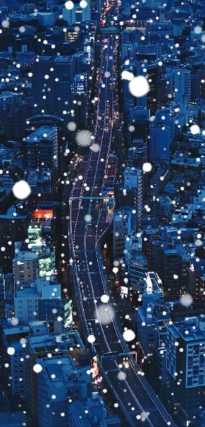 Wallpaper showing a snowy city night scene with vibrant blue tones.