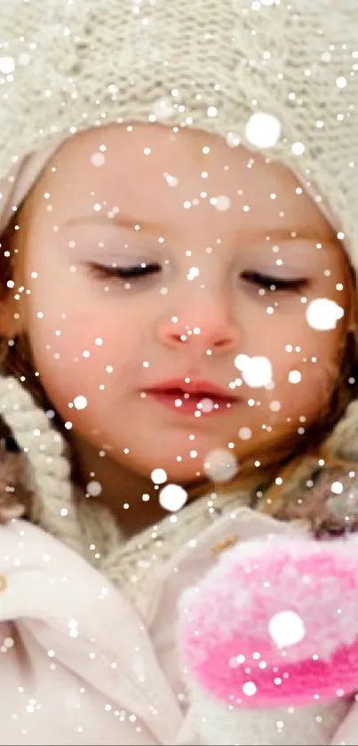 Child in white coat and pink mittens in a snowy landscape.
