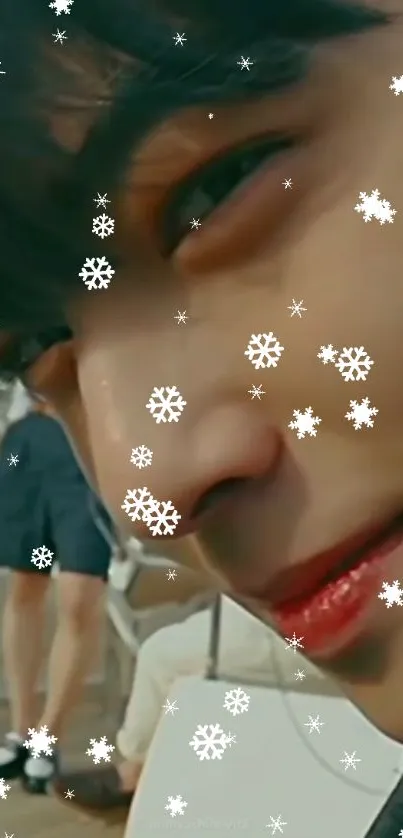 Close-up of a serene face with snowflakes overlay.