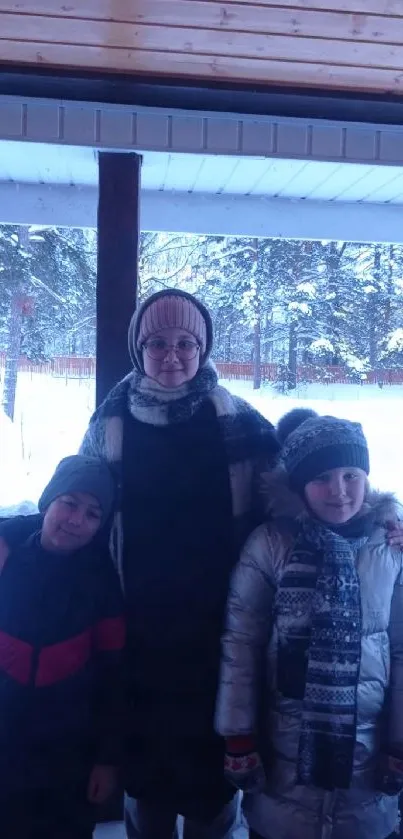 Family standing together in snowy outdoor setting with warm winter clothing.