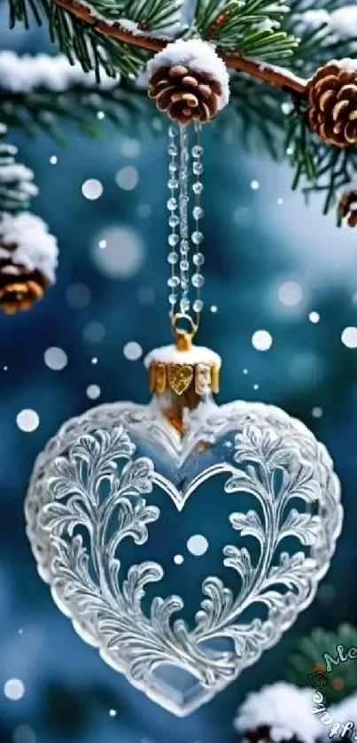 Heart-shaped ornament hanging from snowy pine branch.