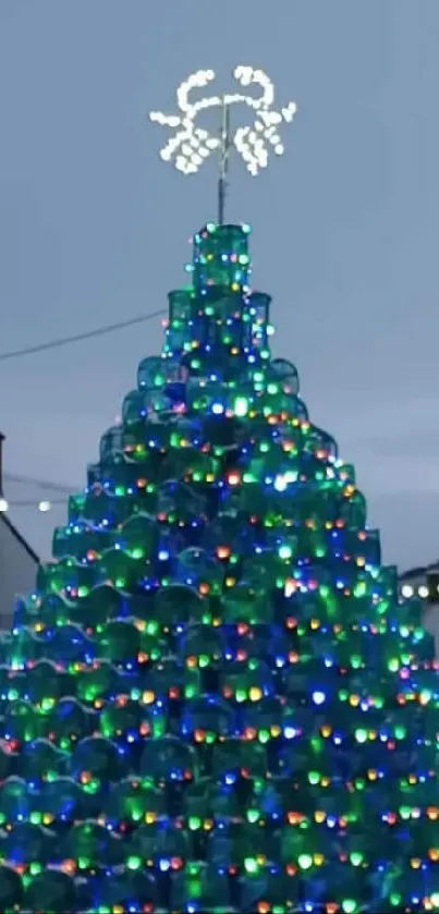 Snowy holiday village with Christmas tree and lights.