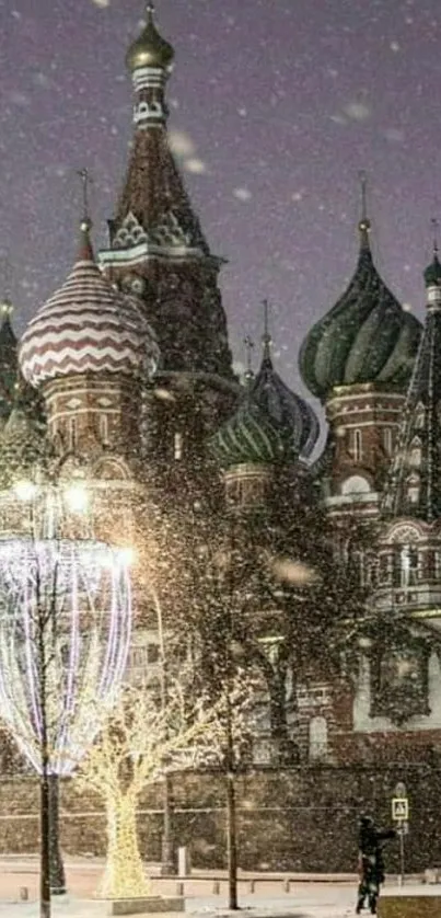 Snow-covered Kremlin in Moscow at night with lights and festive snow.