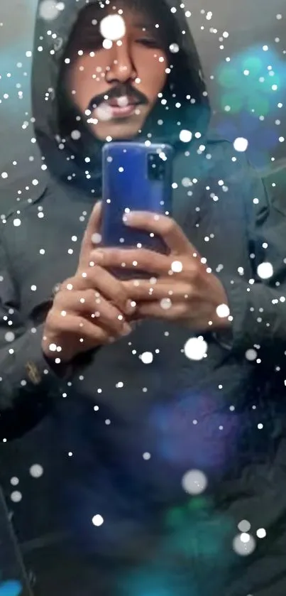 Hooded man in mirror with snow effect on phone wallpaper.