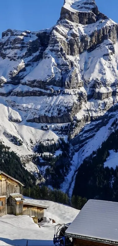 Chalet nestled beneath a majestic snowy mountain.
