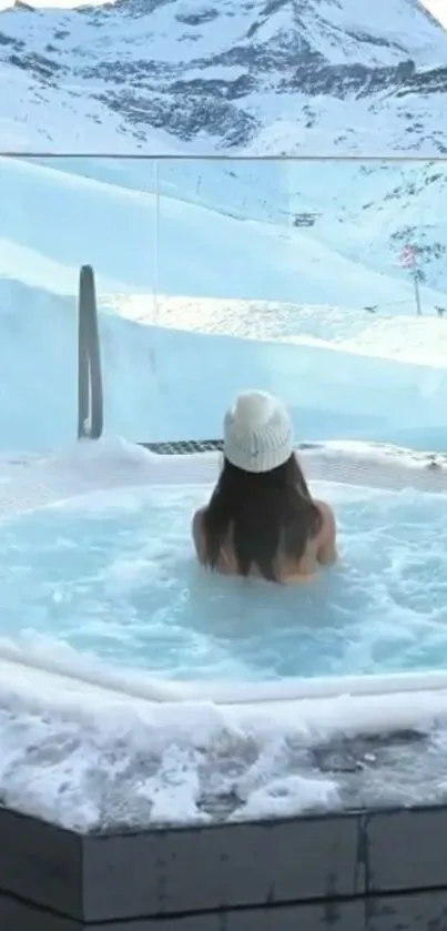 Woman in hot tub with snowy mountain view.