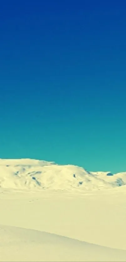 Snowy mountain landscape under a clear sky.