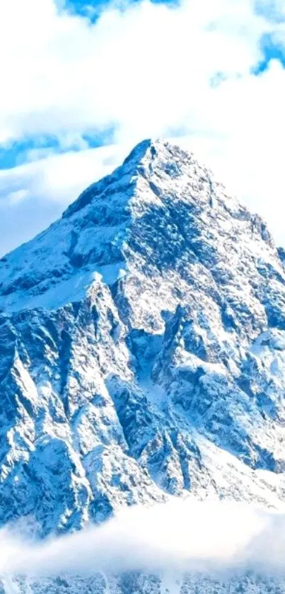 Snow-covered mountain peak against a blue sky wallpaper.