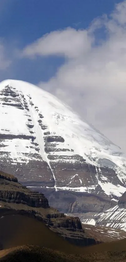 Snow-covered mountain peak under blue sky.