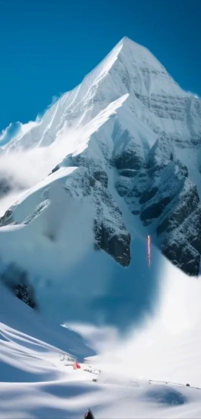 Snow-covered mountain peak under a clear blue sky.