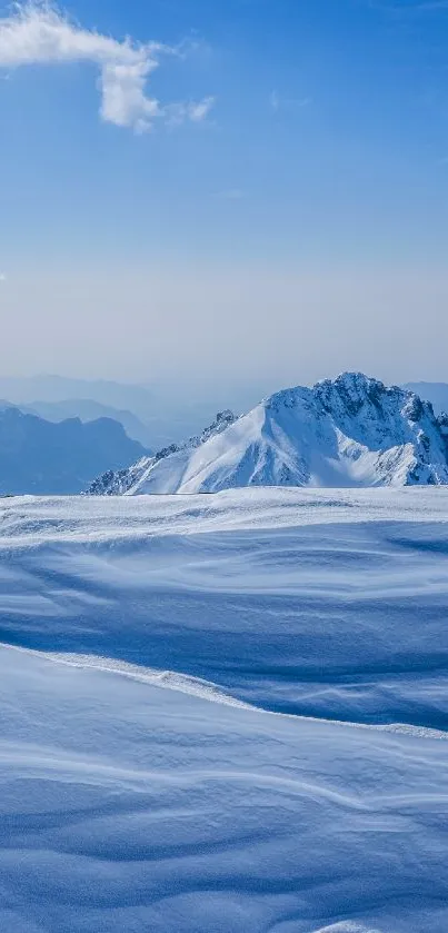 Tranquil snowy mountain peaks beneath a clear blue sky.