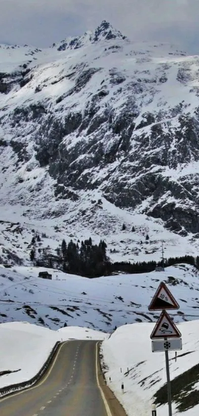 Snowy mountain road with scenic views.