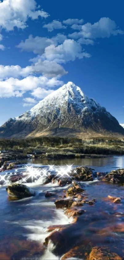 Snowy mountain peak above a serene river under a clear blue sky.