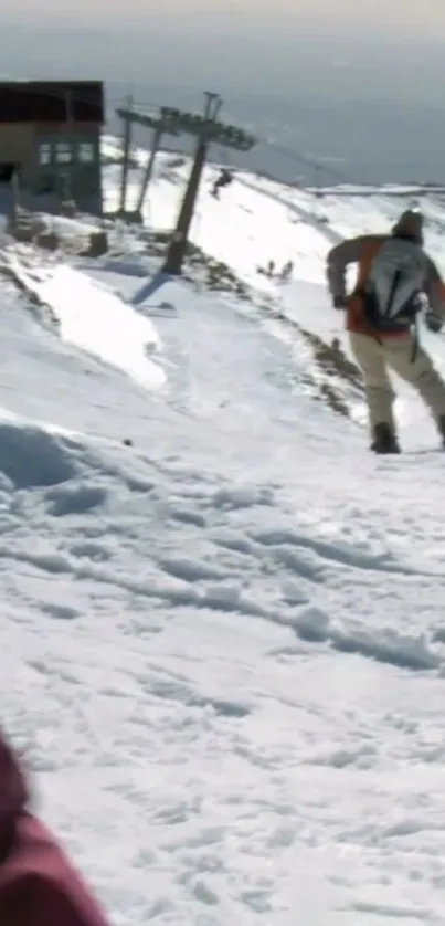 Snowy mountain slope with a skier descending.