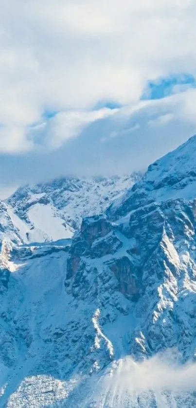 Snowy mountain peaks under a blue sky, creating a serene mobile wallpaper.