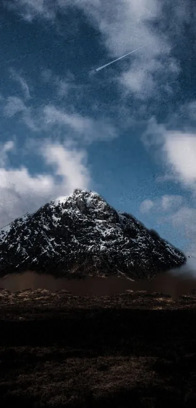 Snowy mountain beneath a vibrant blue sky with clouds.